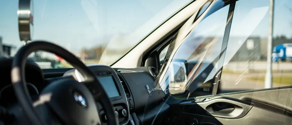 View from the driver seat through the windshield and side glass of a van
